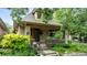 Inviting covered porch with brick columns and railing, leading to the front entrance of the home at 2975 Irving St, Denver, CO 80211