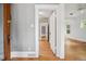 Hallway with hardwood floors leading to additional rooms, showing the layout and flow of the home at 2975 Irving St, Denver, CO 80211
