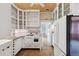 Cozy kitchen with retro appliances, white cabinetry, and unique wood-paneled ceiling at 2975 Irving St, Denver, CO 80211