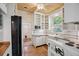 Charming kitchen with white cabinets, stainless steel microwave and white subway tile backsplash at 2975 Irving St, Denver, CO 80211