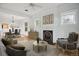Cozy living room featuring a fireplace, hardwood floors, decorative windows, and an open dining area at 2975 Irving St, Denver, CO 80211