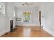 Spacious living room featuring hardwood floors, decorative windows, and a cozy fireplace at 2975 Irving St, Denver, CO 80211