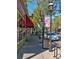 Street view of the charming Highlands Square, lined with shops and sidewalks bustling with activity at 2975 Irving St, Denver, CO 80211
