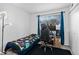 Bright bedroom with modern desk setup, comfortable twin bed and neutral walls at 3546 S Depew St # 103, Denver, CO 80235