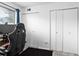 Bright room featuring a black desk chair and closet doors at 3546 S Depew St # 103, Denver, CO 80235