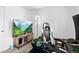 Bright bedroom featuring a gaming chair and wall-mounted television at 3546 S Depew St # 103, Denver, CO 80235