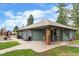 Exterior view of clubhouse with well-manicured lawn, offering a welcoming community gathering space at 3546 S Depew St # 103, Denver, CO 80235
