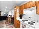Kitchen view features wood cabinets, white countertops and access to dining area at 3546 S Depew St # 103, Denver, CO 80235