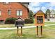 Charming little library boxes on a green lawn, fostering community and reading at 3546 S Depew St # 103, Denver, CO 80235