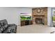 Charming living room with a stone fireplace, modern TV, and comfortable seating at 3546 S Depew St # 103, Denver, CO 80235