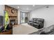 Cozy living room with a stone fireplace, large sliding glass door, and comfortable seating at 3546 S Depew St # 103, Denver, CO 80235