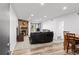 Bright living area with stone fireplace, neutral carpet, and comfortable seating at 3546 S Depew St # 103, Denver, CO 80235
