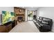Relaxing living room with a stone fireplace and a sliding glass door to the outdoor space at 3546 S Depew St # 103, Denver, CO 80235