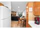 Living room view features stone fireplace, comfortable seating and access to dining area at 3546 S Depew St # 103, Denver, CO 80235