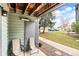 Comfortable outdoor patio with chairs and a green outdoor view at 3546 S Depew St # 103, Denver, CO 80235