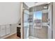 Modern bathroom with gray tile, a glass-enclosed shower, and a bright window at 4036 Navajo St, Denver, CO 80211