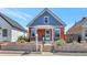 Brick front home featuring a covered front porch and well maintained front yard at 4036 Navajo St, Denver, CO 80211