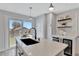 Bright kitchen featuring stainless steel appliances, a white countertop island, and backyard views at 4036 Navajo St, Denver, CO 80211