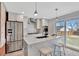 Modern kitchen features stainless steel appliances, white cabinets, and a large center island with seating at 4036 Navajo St, Denver, CO 80211