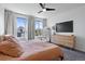 Comfortable bedroom with a large mirror, dresser, and ample natural light from windows overlooking neighborhood at 4950 Lowell Blvd, Denver, CO 80221