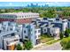 Modern townhouse exterior showcasing sleek design, large windows, and a view of the city skyline in the background at 4950 Lowell Blvd, Denver, CO 80221