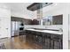 Modern kitchen featuring stainless steel appliances, a large island with bar seating, and hardwood flooring at 4950 Lowell Blvd, Denver, CO 80221