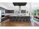 Sleek modern kitchen featuring an island with bar seating, stainless steel appliances, and ample storage at 4950 Lowell Blvd, Denver, CO 80221