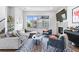 Spacious living room with comfortable seating, large windows providing lots of light, and a modern fireplace at 4950 Lowell Blvd, Denver, CO 80221