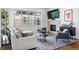 Cozy living room featuring neutral tones, comfortable seating, fireplace, and a large window for natural light at 4950 Lowell Blvd, Denver, CO 80221