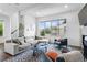 Bright living room featuring a comfortable sofa, modern accents, large window with neighborhood views at 4950 Lowell Blvd, Denver, CO 80221