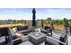 Entertaining rooftop deck featuring a fire pit, dining area and comfortable seating at 4950 Lowell Blvd, Denver, CO 80221