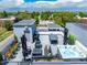 Relax in style with a rooftop deck featuring a hot tub, outdoor seating, a grill, an outdoor dining area, and artificial grass at 4950 Lowell Blvd, Denver, CO 80221
