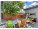 Outdoor living space with wood chairs and string lights at 2107 S Grant St, Denver, CO 80210
