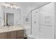 Bright bathroom featuring glass shower, modern fixtures, and neutral-toned vanity at 2107 S Grant St, Denver, CO 80210