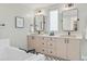 Bathroom features a double vanity, modern fixtures, and a luxurious soaking tub at 2107 S Grant St, Denver, CO 80210