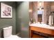 Stylish half-bathroom featuring modern fixtures, decorative mirror, and trendy color scheme at 2107 S Grant St, Denver, CO 80210