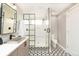 Bathroom featuring patterned tile flooring, a glass enclosed shower, and sleek fixtures at 2107 S Grant St, Denver, CO 80210