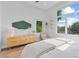 Bright bedroom showcasing large windows and natural light with stylish mid-century furnishings at 2107 S Grant St, Denver, CO 80210