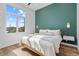 Cozy bedroom with bright natural light and stylish sconce lighting and a clean aesthetic at 2107 S Grant St, Denver, CO 80210