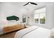 Light filled bedroom with a large window, a stylish dresser, and sleek shelving at 2107 S Grant St, Denver, CO 80210