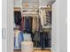 Organized walk-in closet with ample hanging space, shelving, and seating for a complete wardrobe solution at 2107 S Grant St, Denver, CO 80210