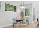 Bright dining room featuring a wooden table, seating for six, and natural light from large windows at 2107 S Grant St, Denver, CO 80210