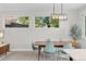 Inviting dining area with a modern light fixture, seating for six, and large windows at 2107 S Grant St, Denver, CO 80210