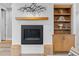 Modern fireplace with decorative mantel, built-in shelving, and access to a cozy living area at 2107 S Grant St, Denver, CO 80210