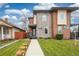 Beautiful modern home featuring a manicured lawn, stone facade, and inviting entryway at 2107 S Grant St, Denver, CO 80210