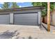 Spacious two-car garage with gray doors and concrete driveway at 2107 S Grant St, Denver, CO 80210