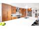 Spacious kitchen with wood cabinetry, modern stainless steel appliances, and large island at 2107 S Grant St, Denver, CO 80210
