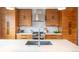 Gourmet kitchen with custom wood cabinets, stainless steel appliances, and marble backsplash at 2107 S Grant St, Denver, CO 80210