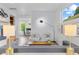 Bright, open living room featuring modern decor, sleek lighting, and views into an office at 2107 S Grant St, Denver, CO 80210