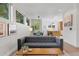 Well-lit living room with views into the dining area, featuring a cozy couch and area rug at 2107 S Grant St, Denver, CO 80210